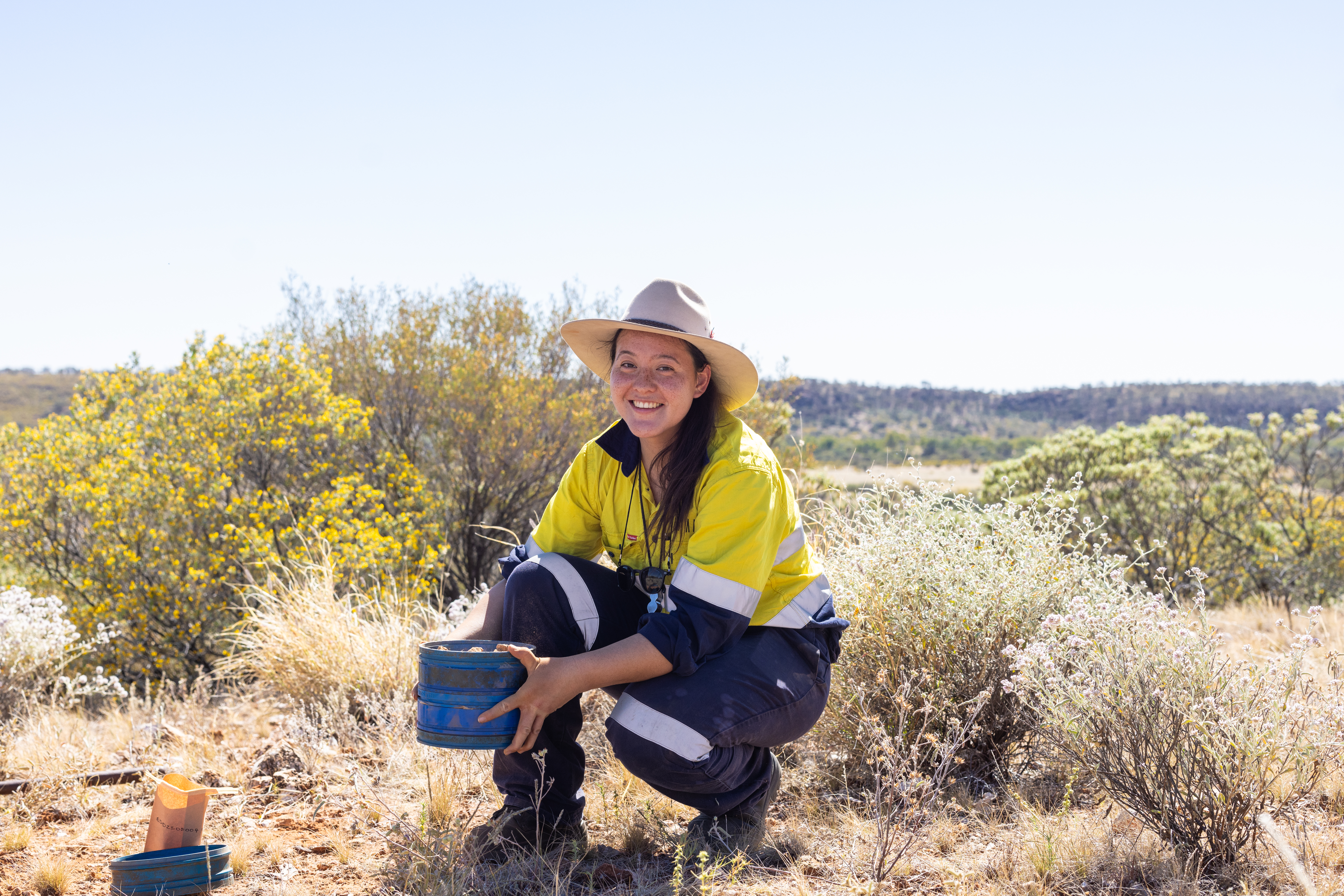 Worker undertaking fieldwork in a natural landscape.