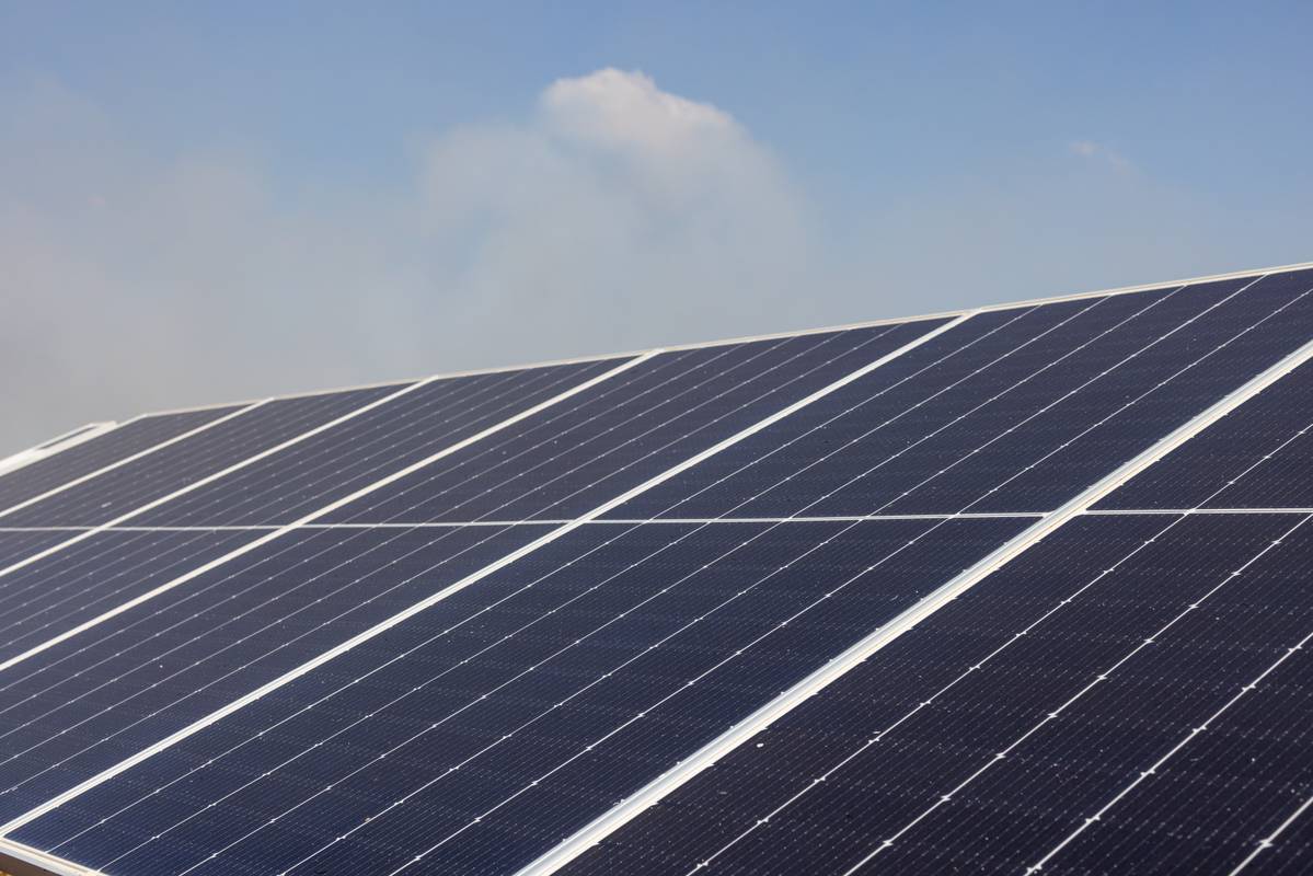 A solar panel array under a clear blue sky.