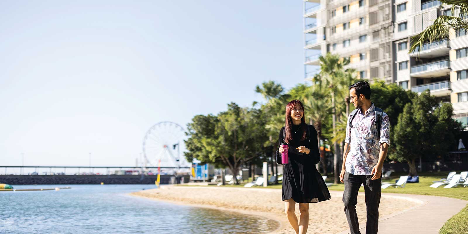 Couple walking along beachfront